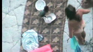 Naked Couple Stretches Slowly On The Beach