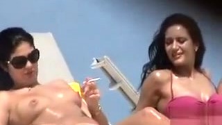 Oiled Up Topless Hottie Smokes A Cigarette At The Beach